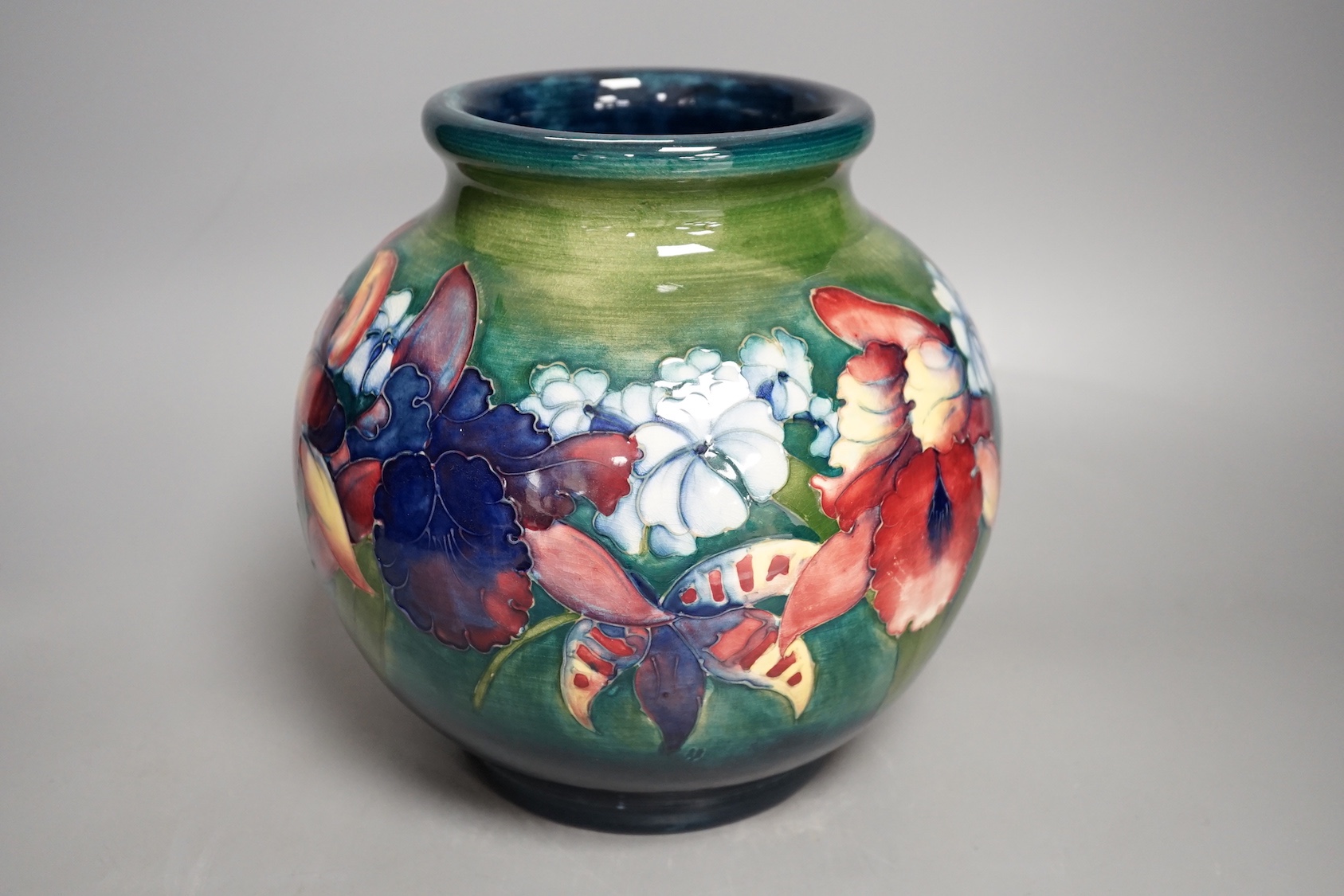 A Moorcroft green glaze 'spring flowers' squat vase, 21 cms high.